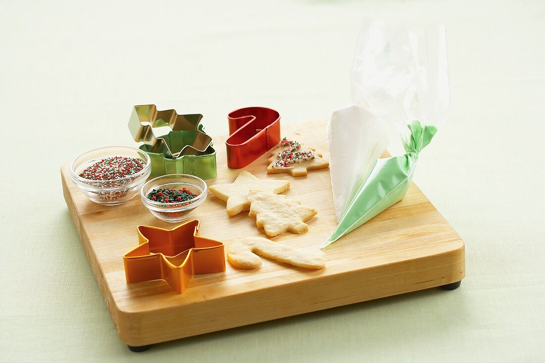 Baked Cookies, Cookie Cutters and Decorations on a Wooden Board