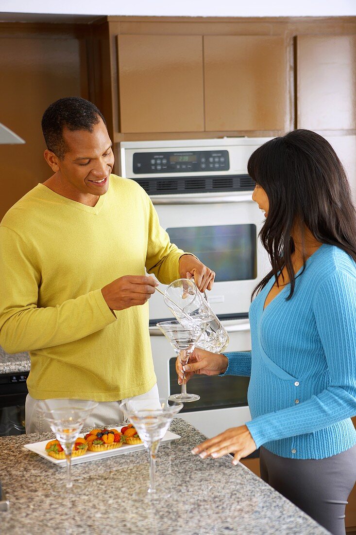 Man mixing a drink in a kitchen