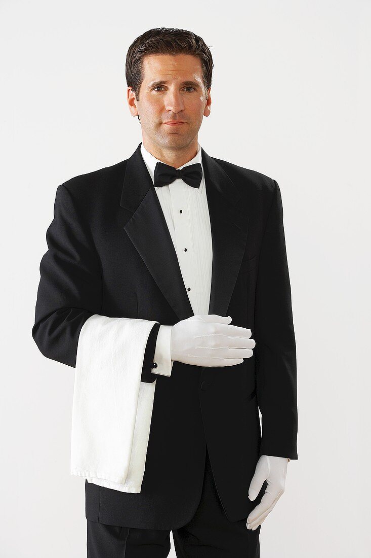 Elegant waiter in dinner jacket