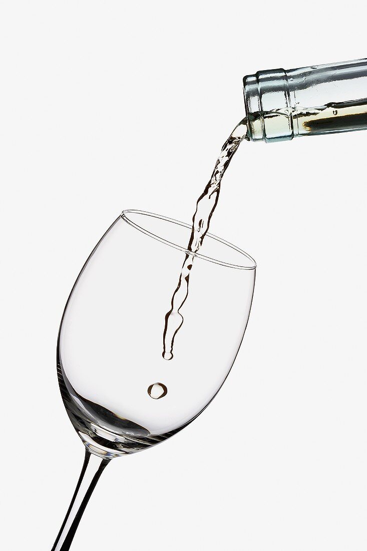 White Wine Pouring into a Glass