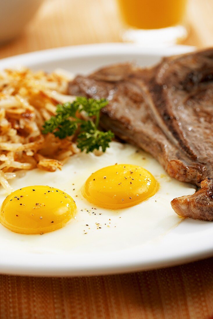 Fried Eggs with Steak and Shredded Homefried Potatoes (Close Up)