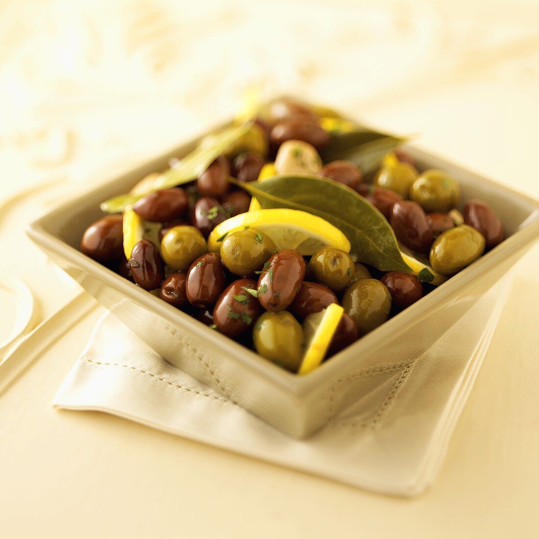 Marinated Olives with Lemon and Bay Leaves in a Bowl