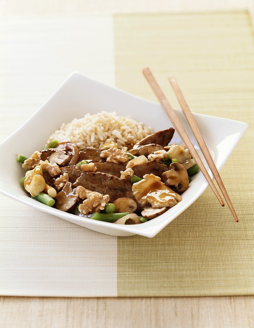 Mushroom and Beef Stir Fry with Rice and Chopsticks