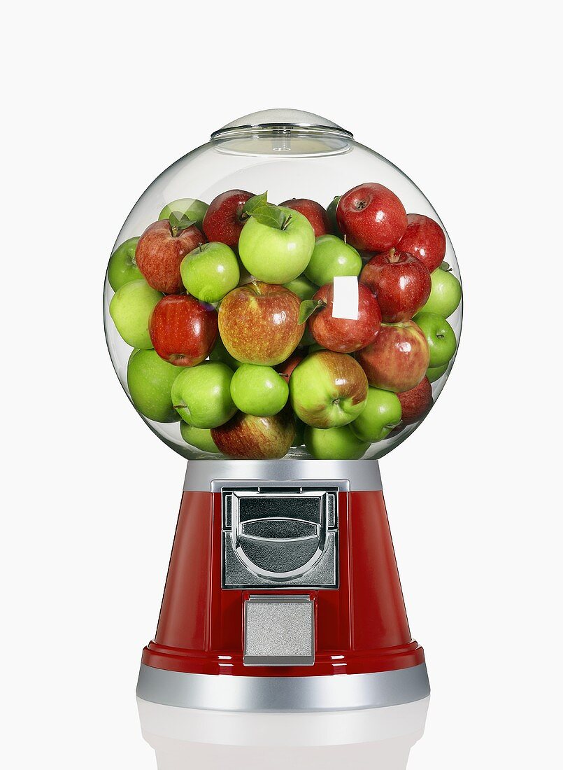 Rote und grüne Äpfel in einem Kaugummiautomat