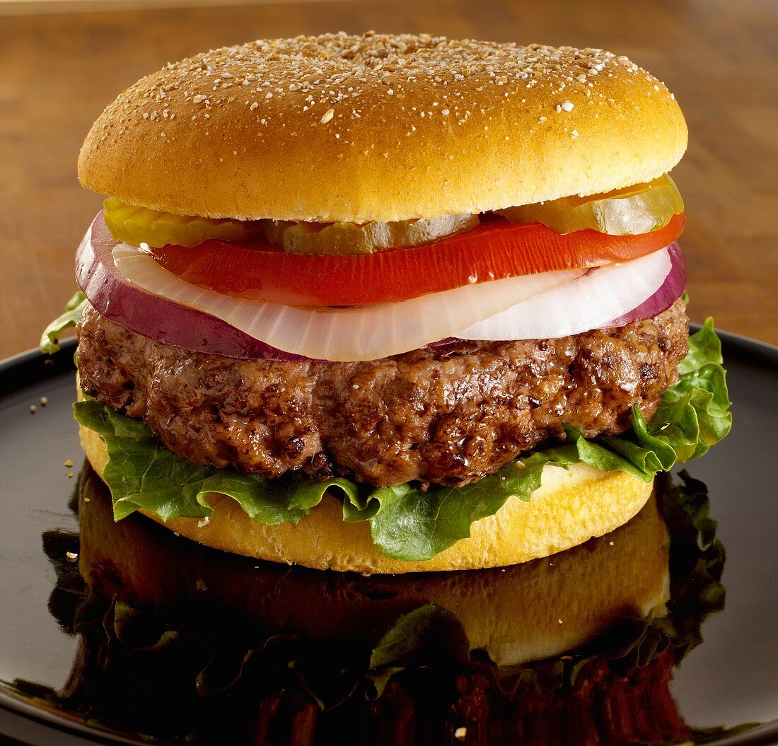 A Thick Angus Burger with Lettuce, Onion, Tomato and Pickles