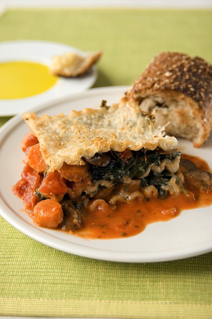A Piece of Vegetable Lasagna with Carrots, Spinach, Mushrooms and Tomatoes
