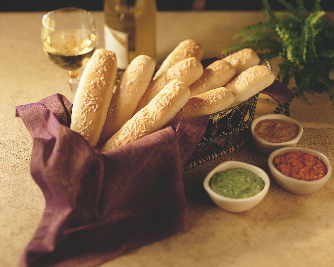 Breadsticks in a Basket with Various Dipping Sauces