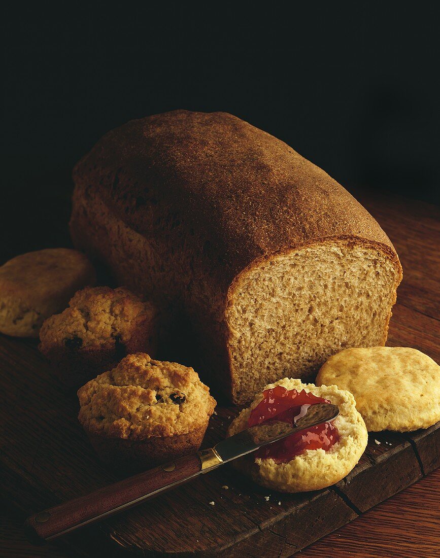 Homemade Bread Loaf, Muffins and a Biscuit with Jam