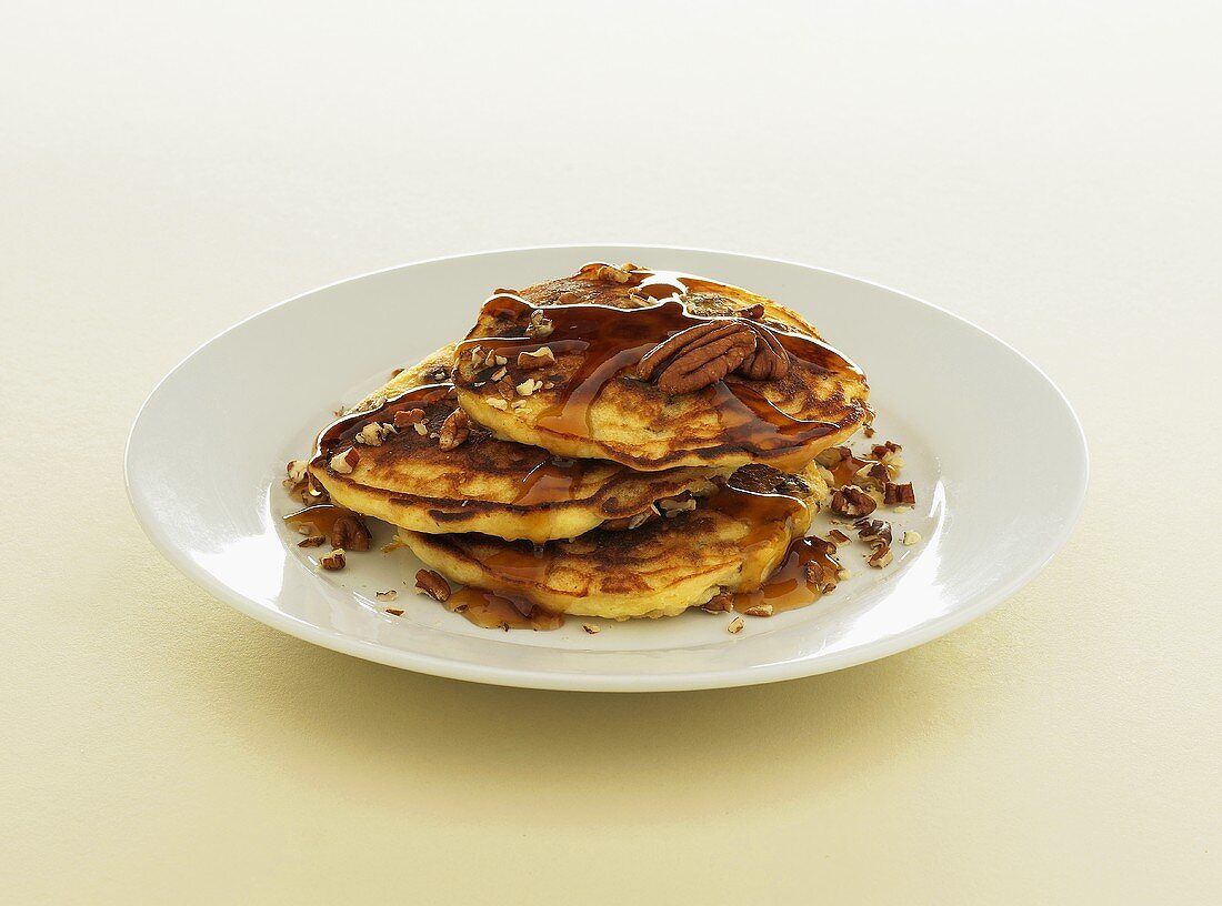 Serving of Pancakes Topped with Maple Syrup and Pecans; Ducklings Pancakes