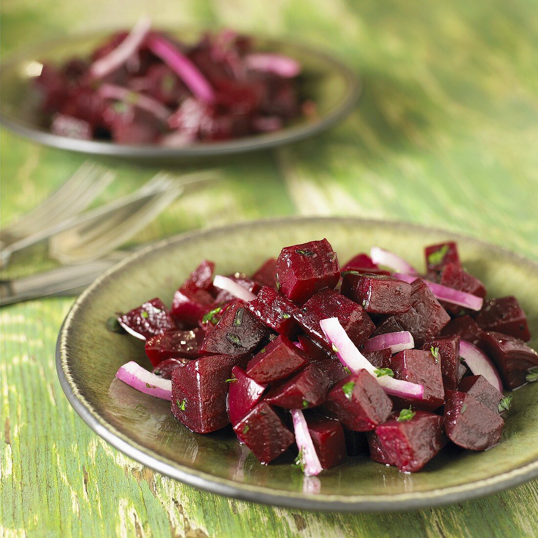 Red Beet and Red Onion Salad Served on Green Plates