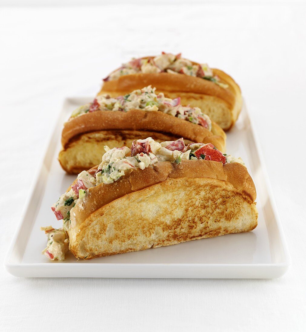 Three Lobster Rolls on a White Tray