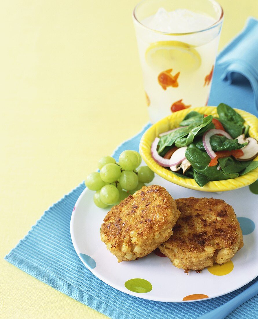 Salmon cakes with grapes and salad
