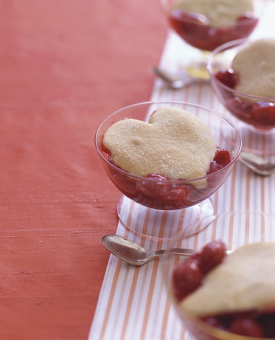 Cherry dessert with heart-shaped biscuit