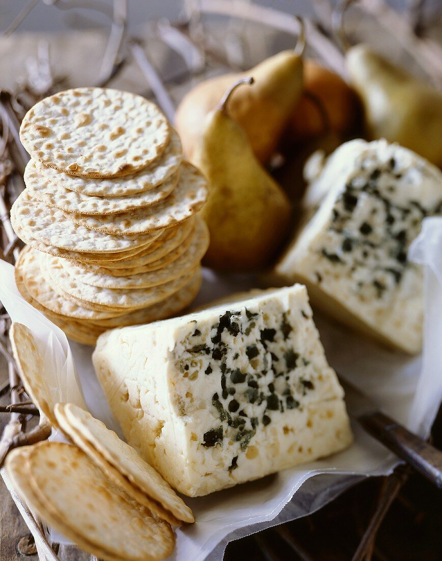Stacks of Water Crackers with Wedges of Bleu de Haut Jura Cheese; Pears