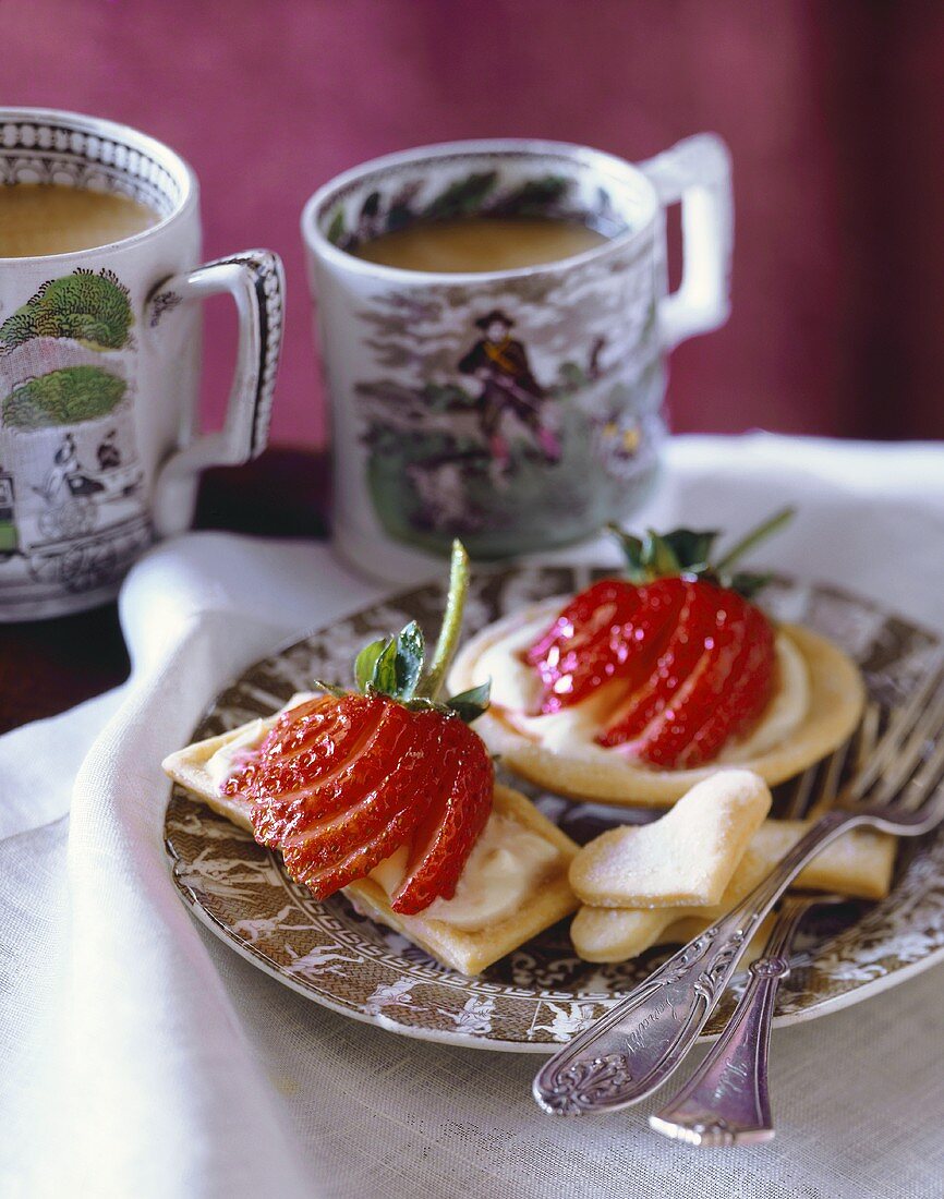 Strawberry Cream Cookie Tarts on a Plate; Cups of Coffee