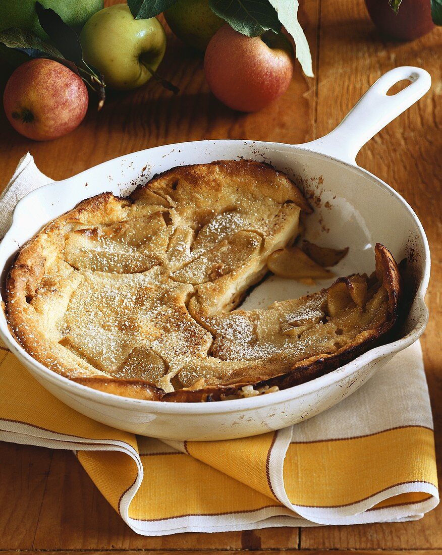 Apple Pancake in a White Skillet with Slice Removed