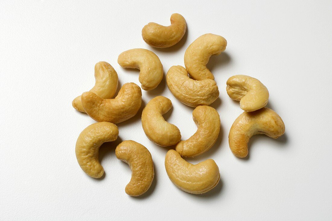 Several cashews on white background