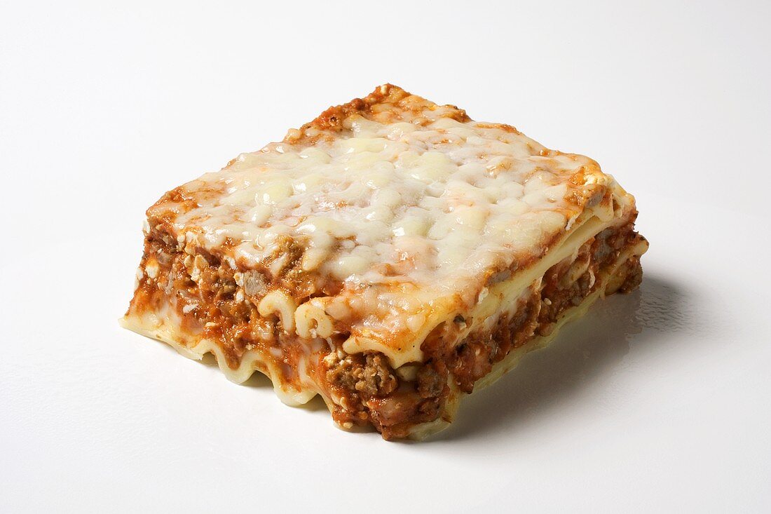 Piece of lasagna on white background