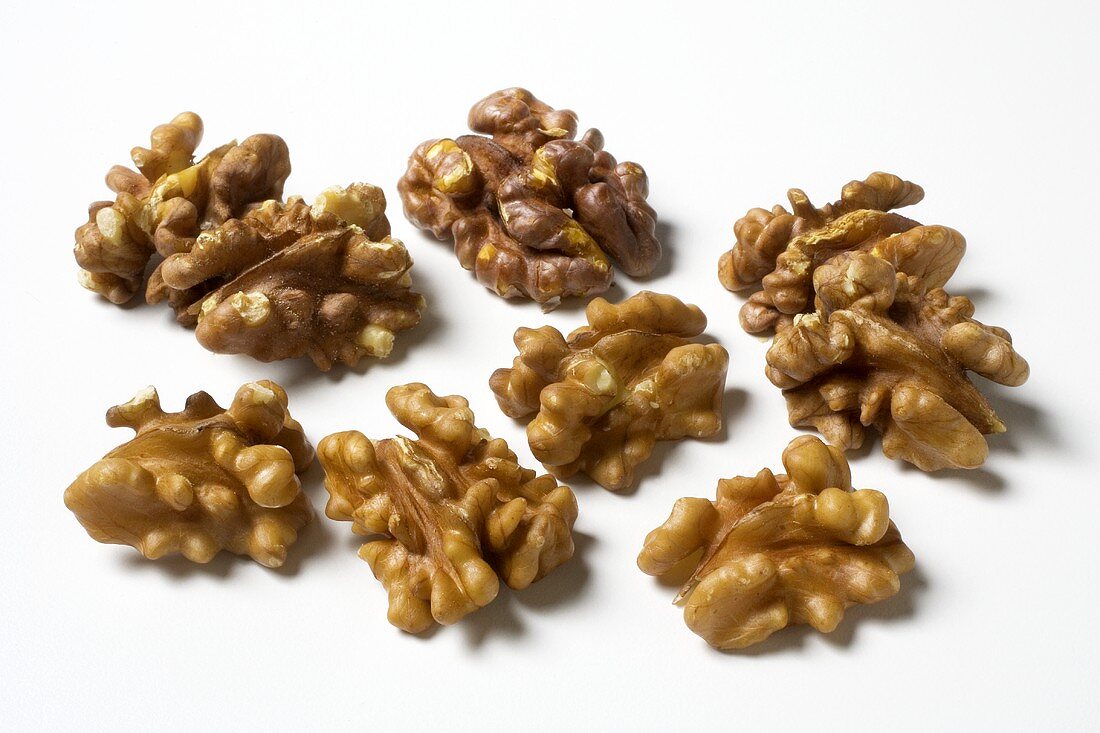 Several walnuts on a white background