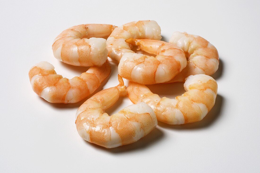 Several cooked shrimp, shells removed