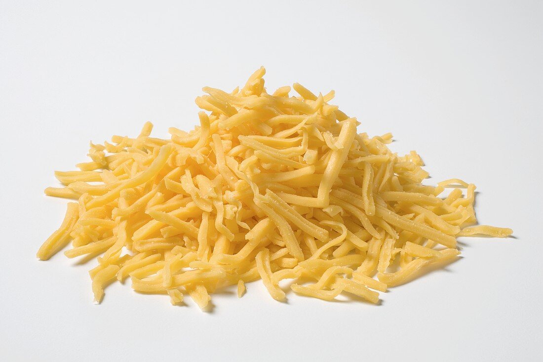 Grated cheese on white background