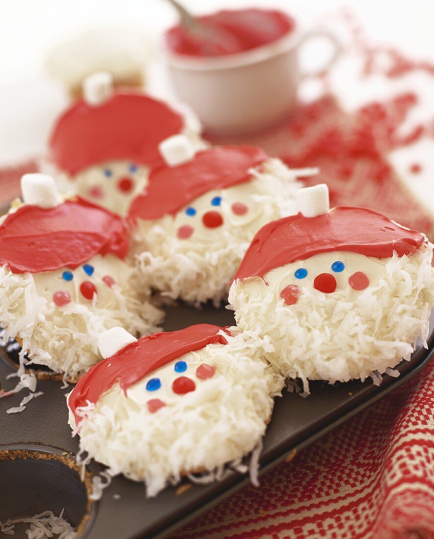 White chocolate coconut biscuits decorated as Father Christmases