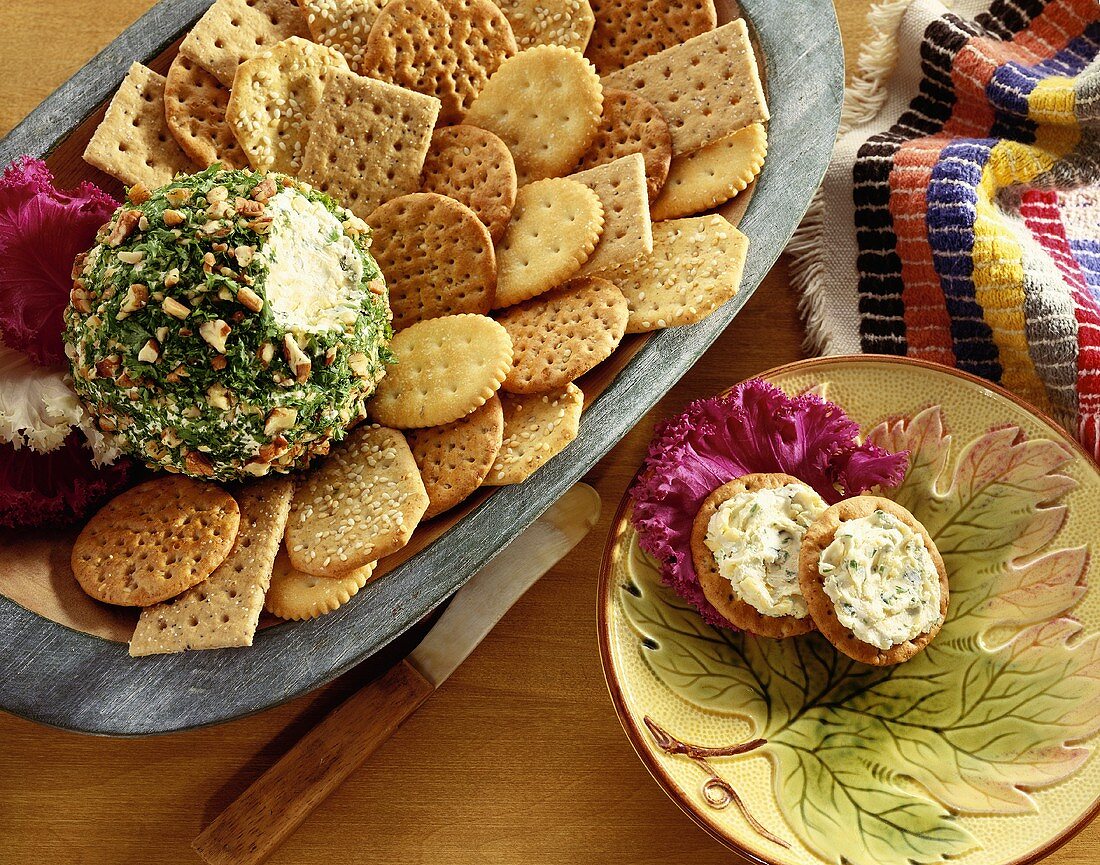 Nut and Herb Coated Cheese Ball on a Platter with Assorted Crackers; Two Crackers with Cheese