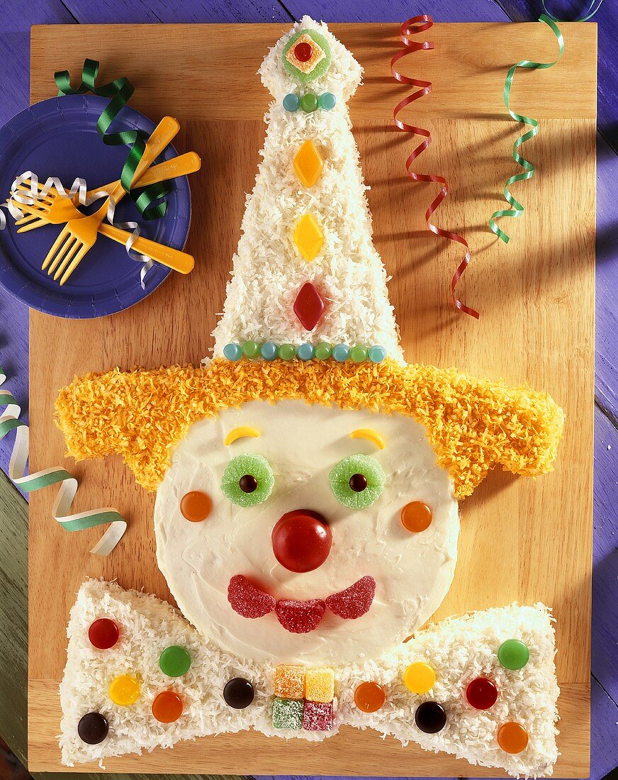 Overhead of Clown Cake for Childs Birthday Party on Wooden Cutting Board