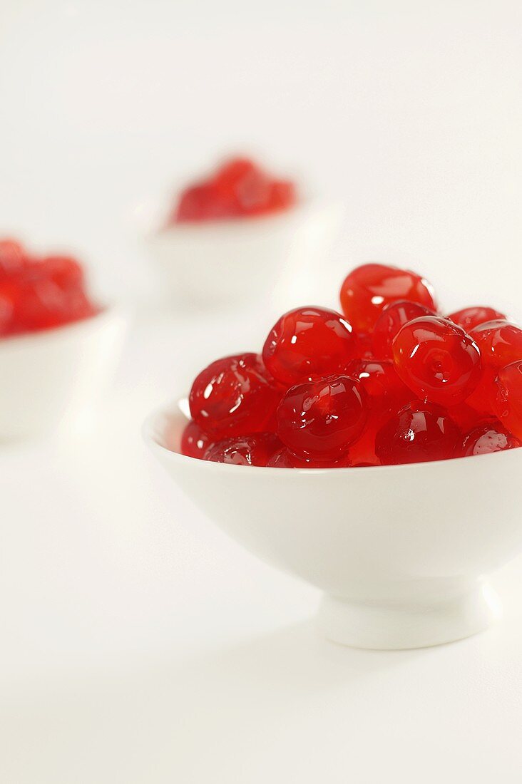 Three Bowls of Candied Red Cherries on White