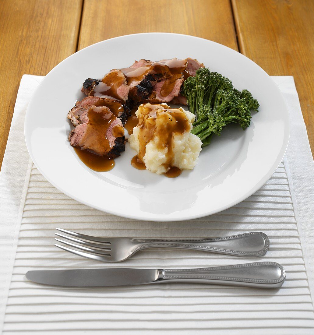 Roast beef with gravy, broccoli and mashed potato