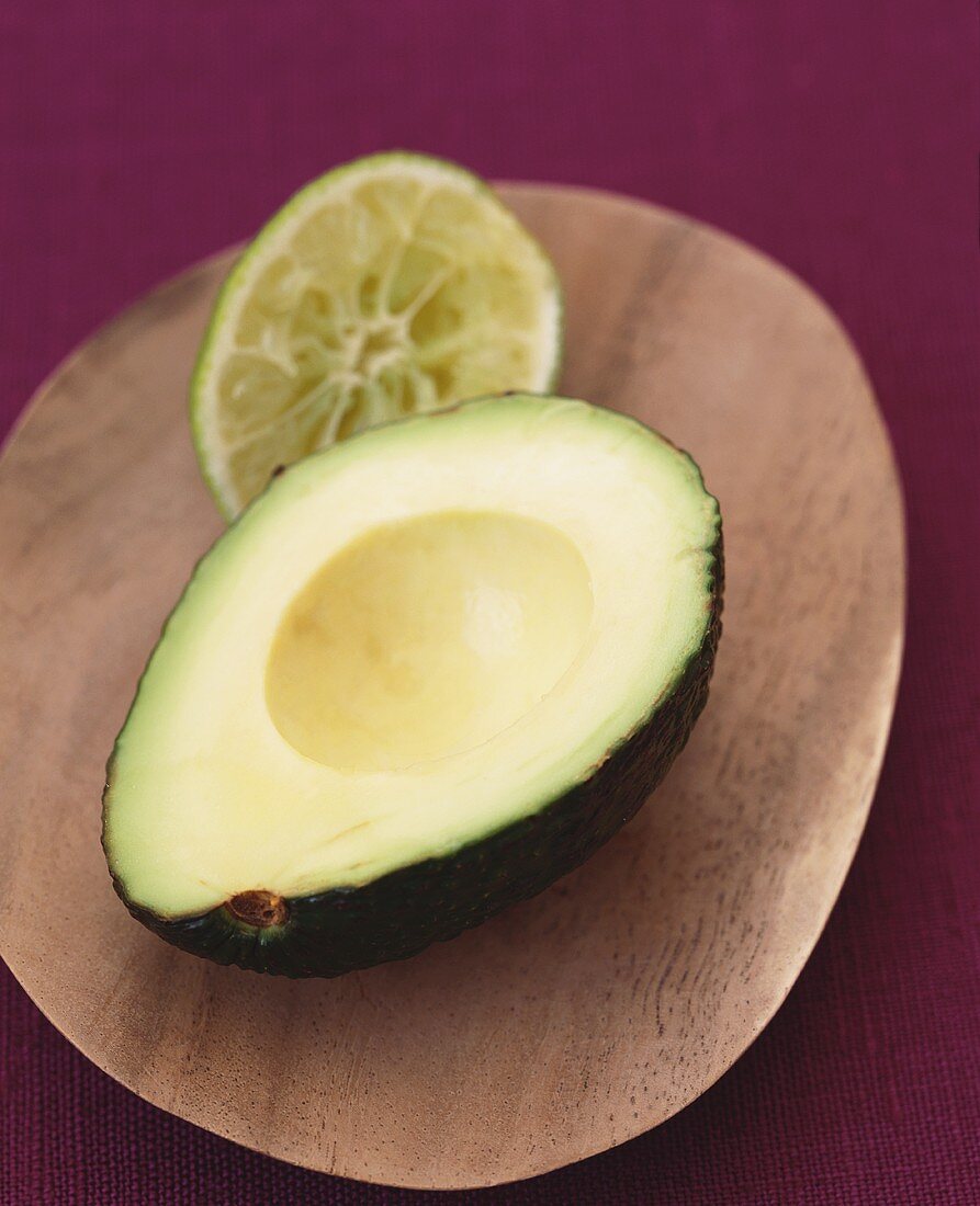 A Pitted Avocado Half and a Squeezed Lime