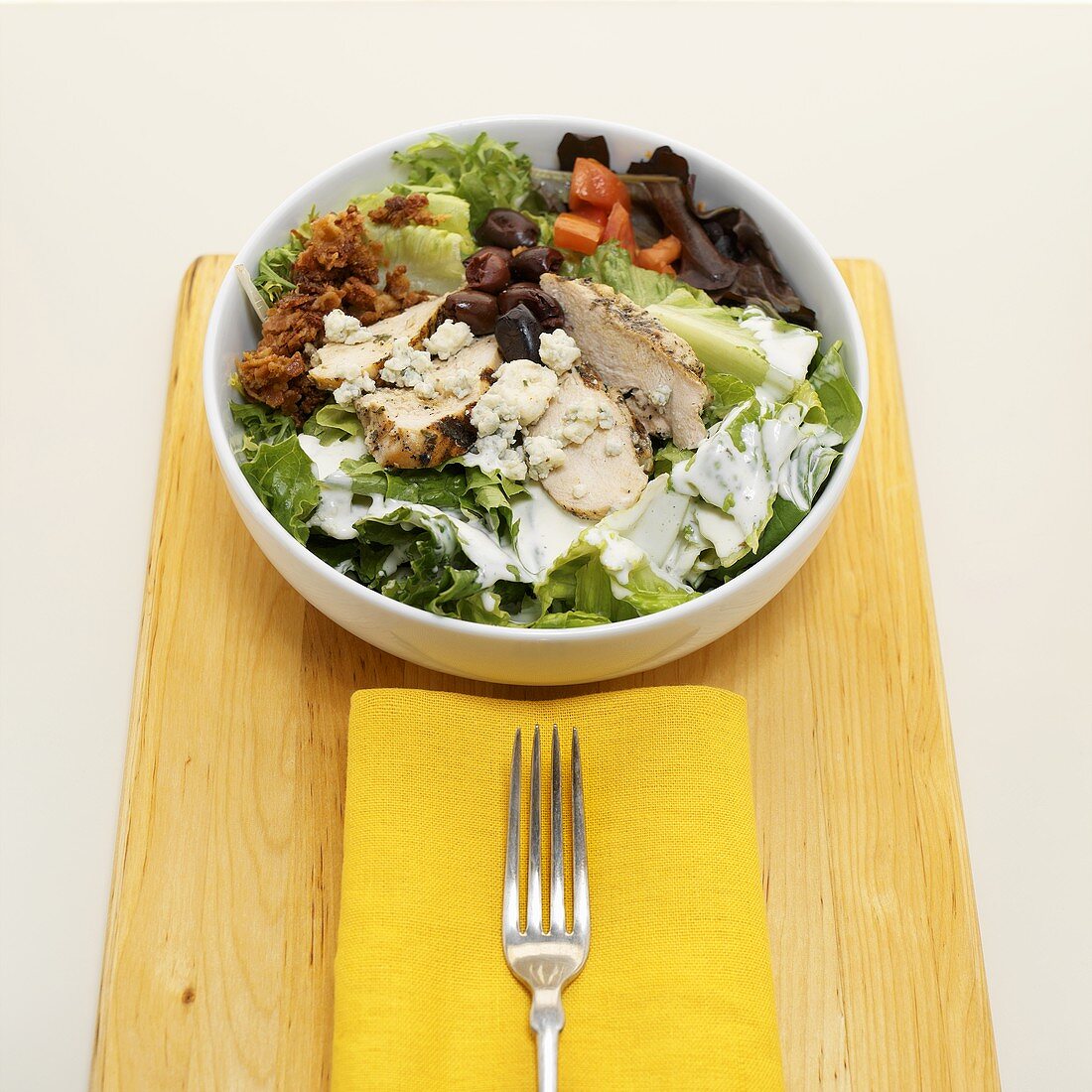 Salad with Chicken, Olives, Bacon, Tomatoes and Blue Cheese in a Bowl