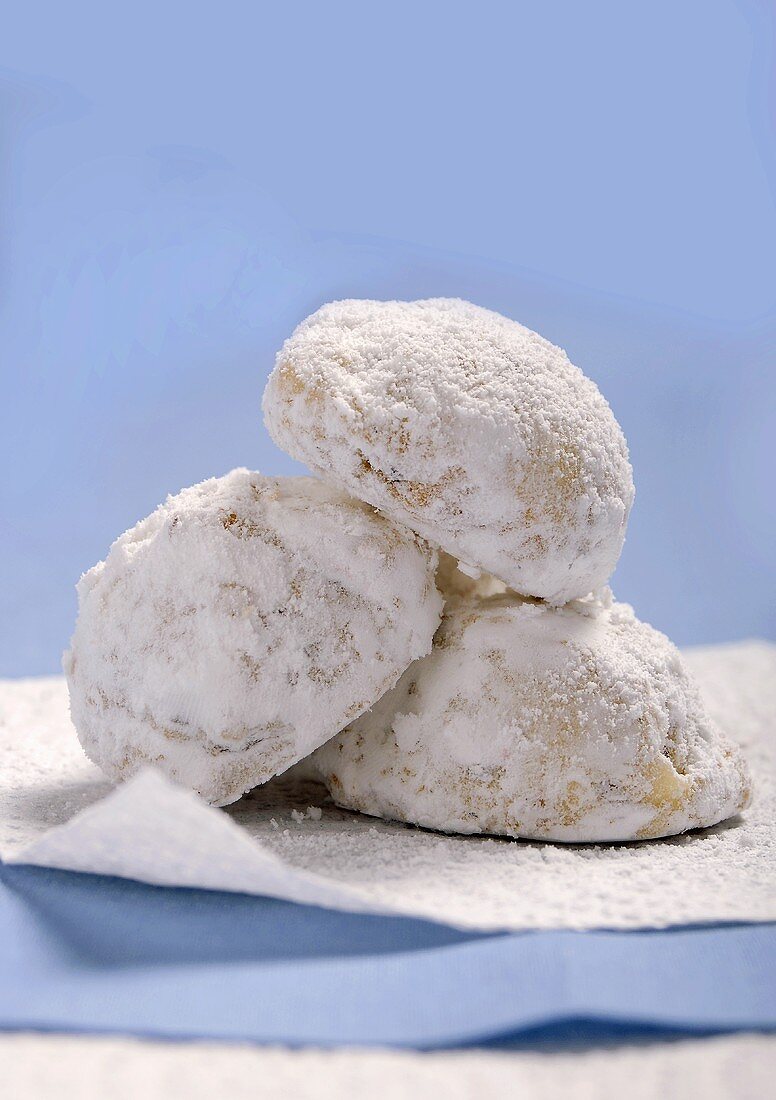 Three Snowball Cookies Stacked on a White Napkin