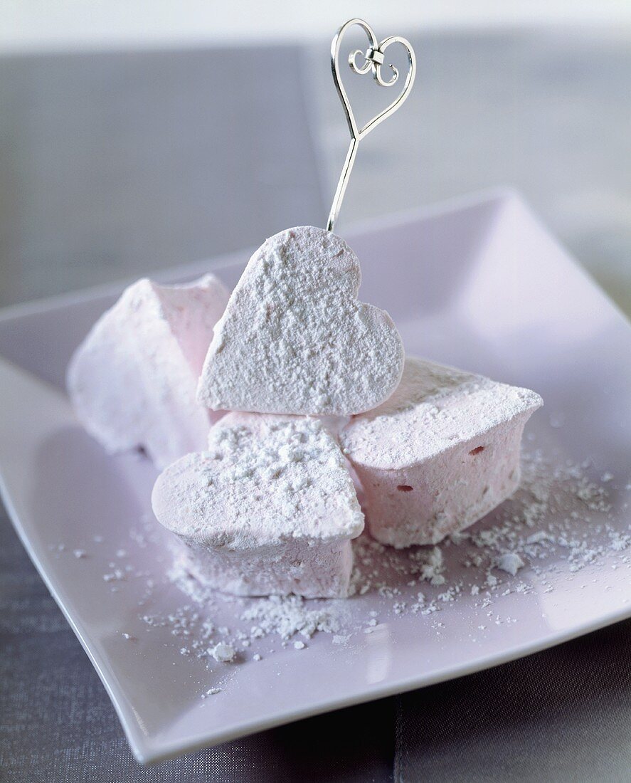 Pink marshmallow hearts with icing sugar
