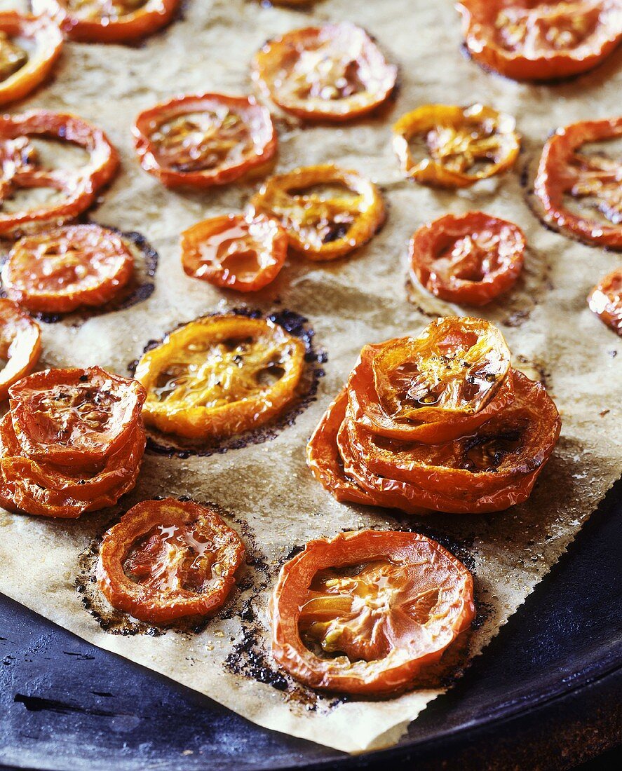 Roasted tomato slices on baking parchment