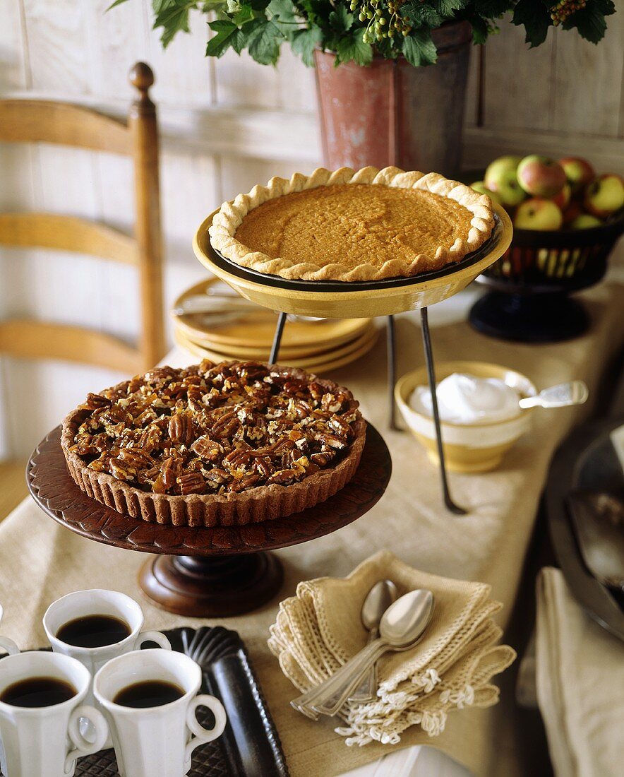 Pecan pie, pumpkin pie and coffee on buffet table