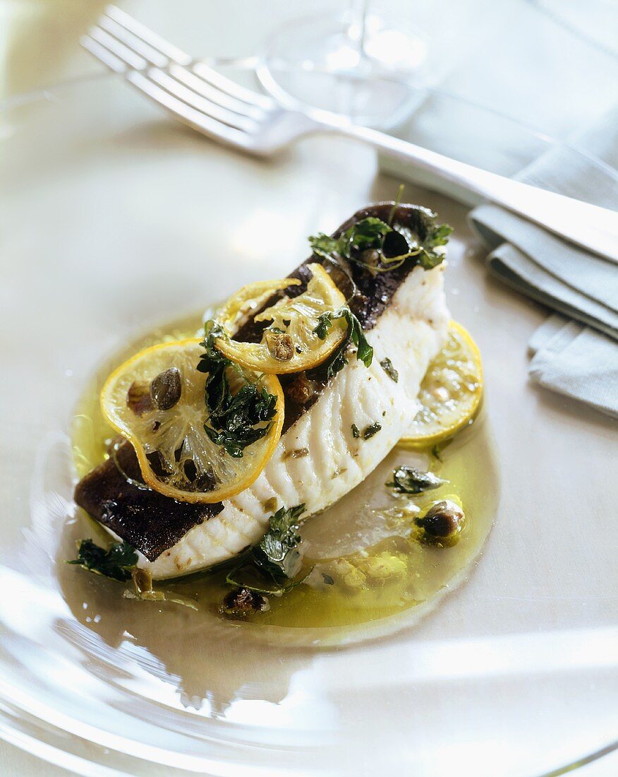 Poached swordfish with lemon and herbs in olive oil