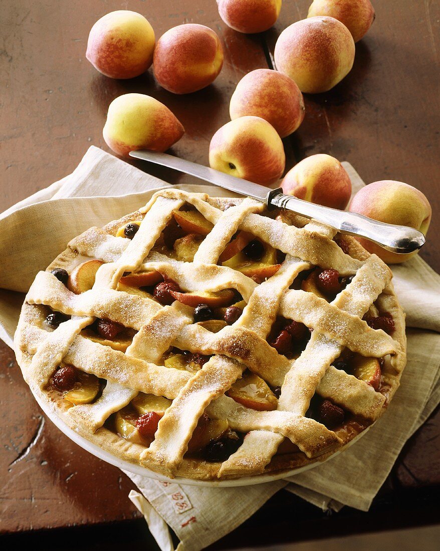 Peach and berry pie with pastry lattice