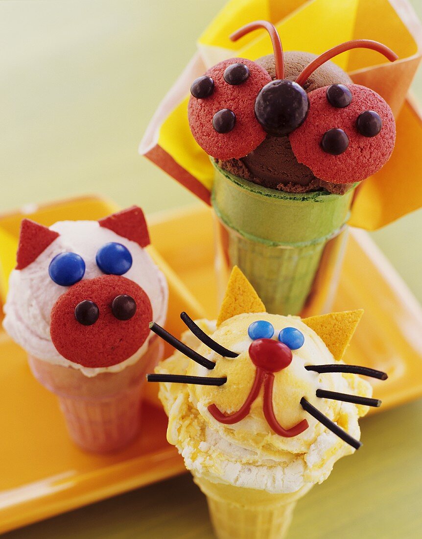 Ice cream cones with scoops of ice cream (amusingly decorated)