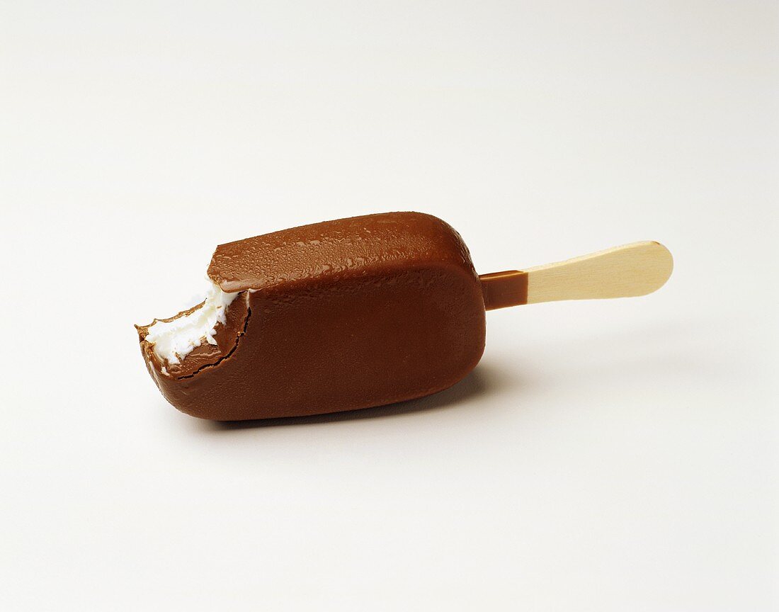 Chocolate-coated ice cream on stick