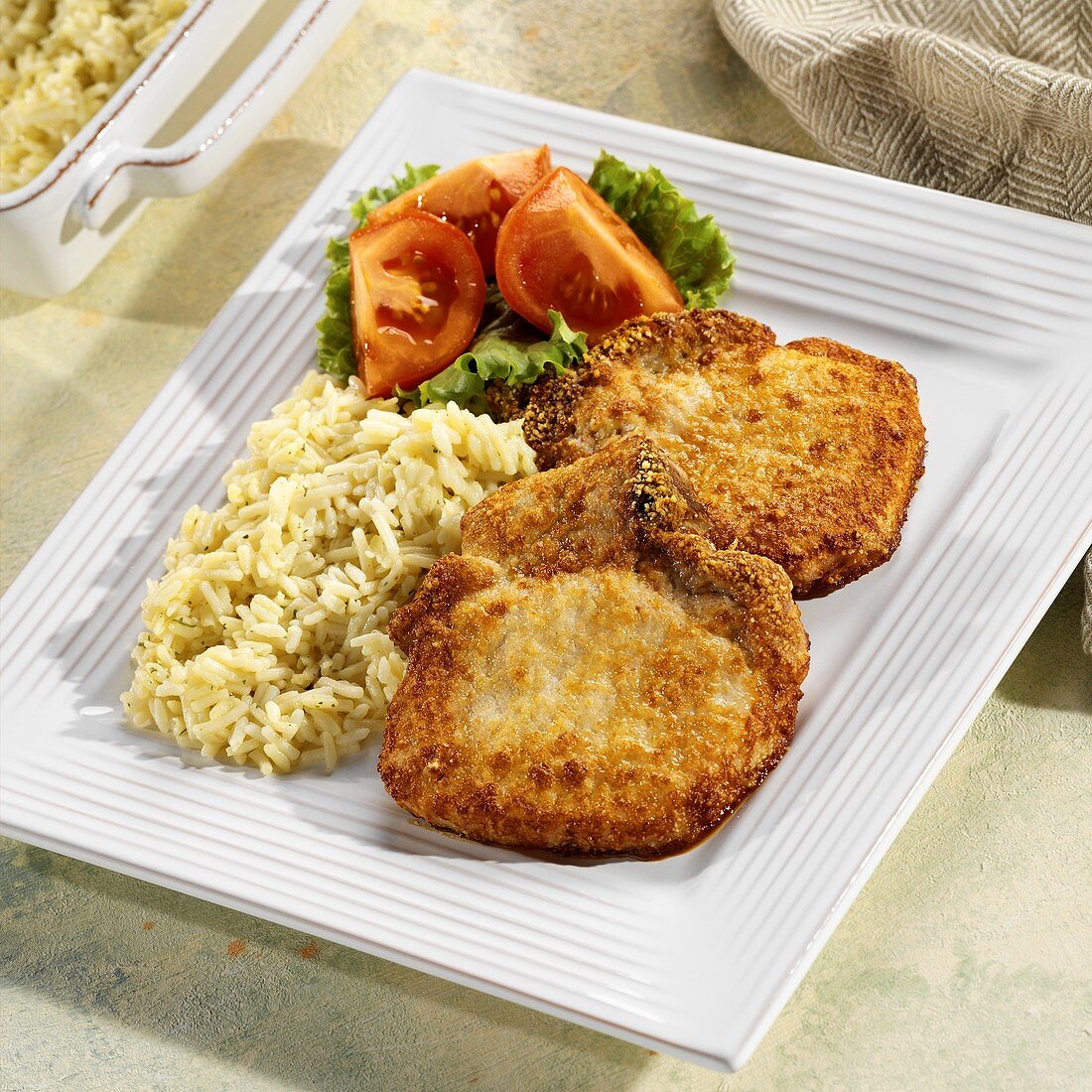 Pork chops with mustard and Parmesan coating and rice