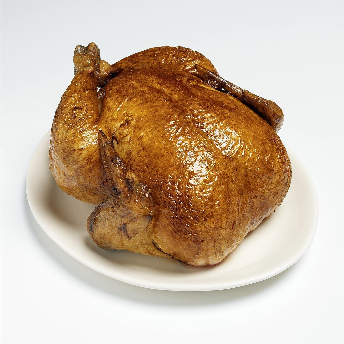 Whole Roast Turkey on a White Platter on White Background