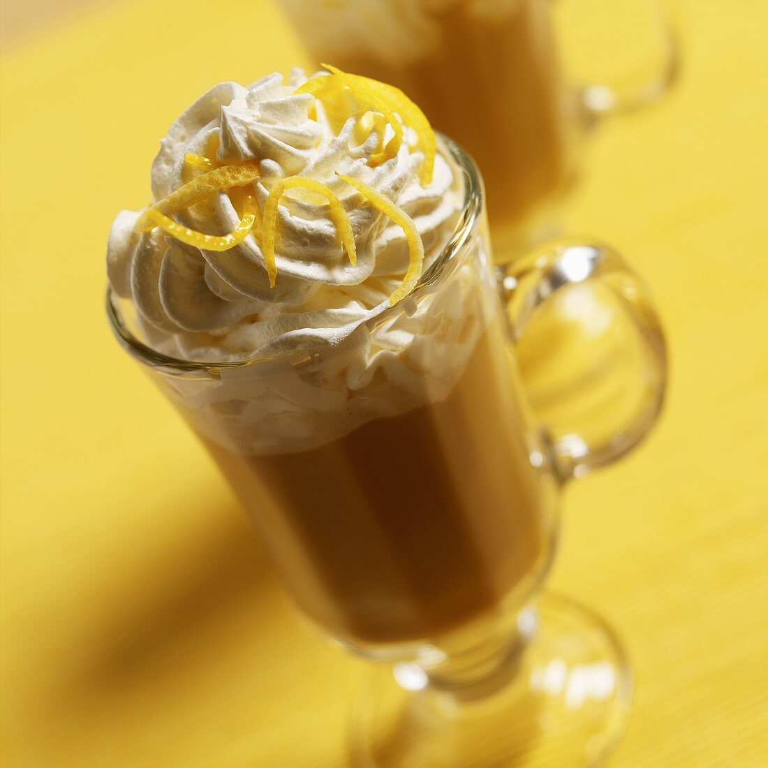 Coffee drink with cream topping and lemon zest
