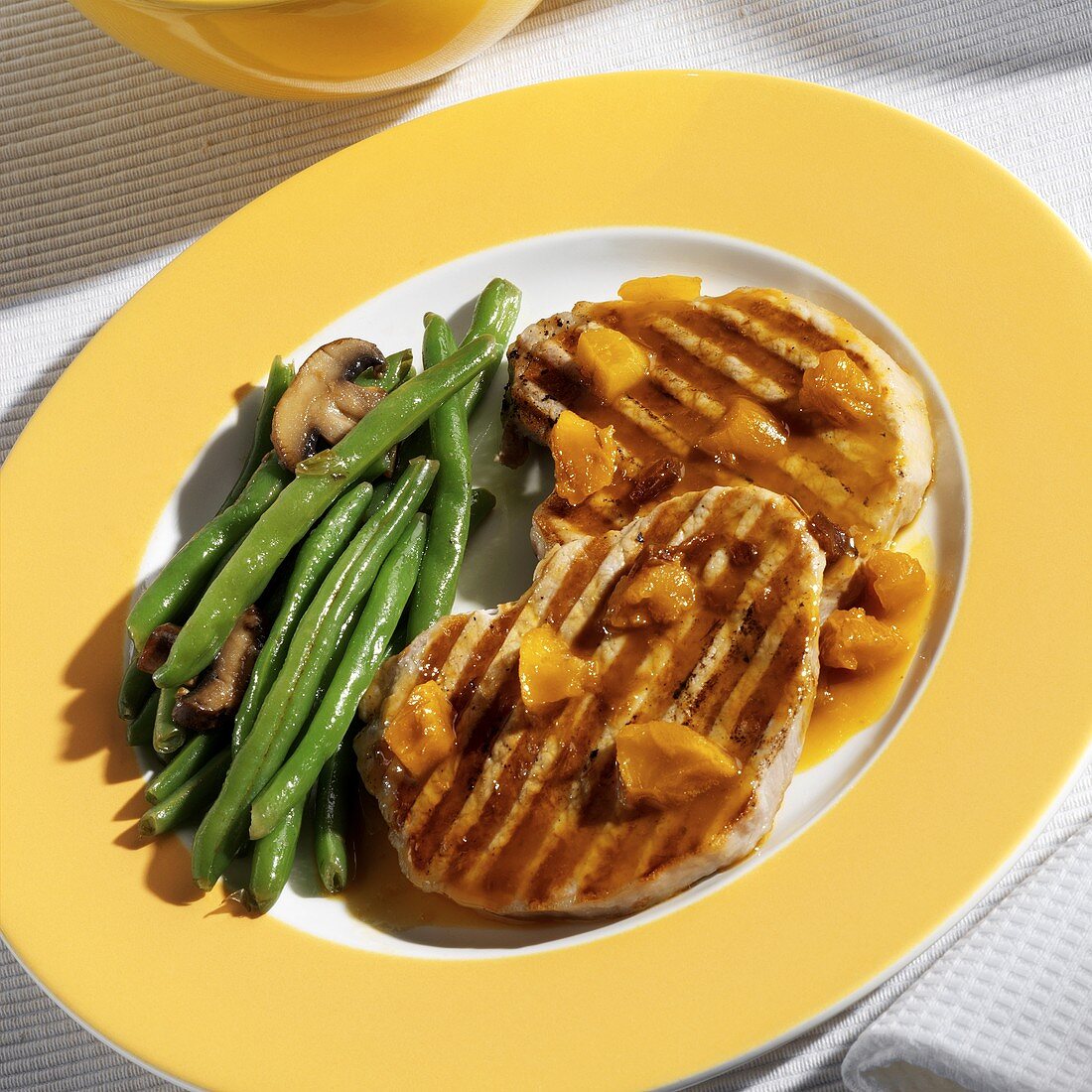 Pork chops with dried fruit, green beans and mushrooms