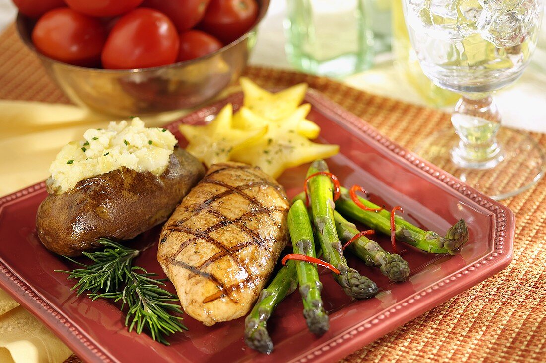 Grilled Chicken Breast with Asparagus and a Baked Potato on a Square Plate