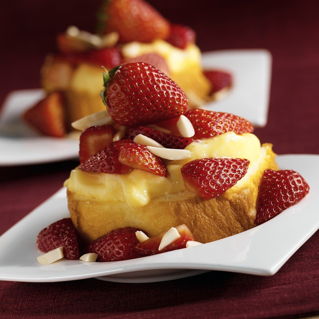 Individual Servings of Rum Cake with Vanilla Pudding, Strawberries and Almonds, Close Up