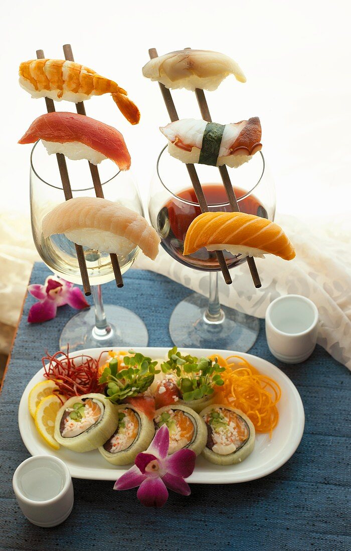 Assorted Sushi on a Platter and on Chopsticks, Wine