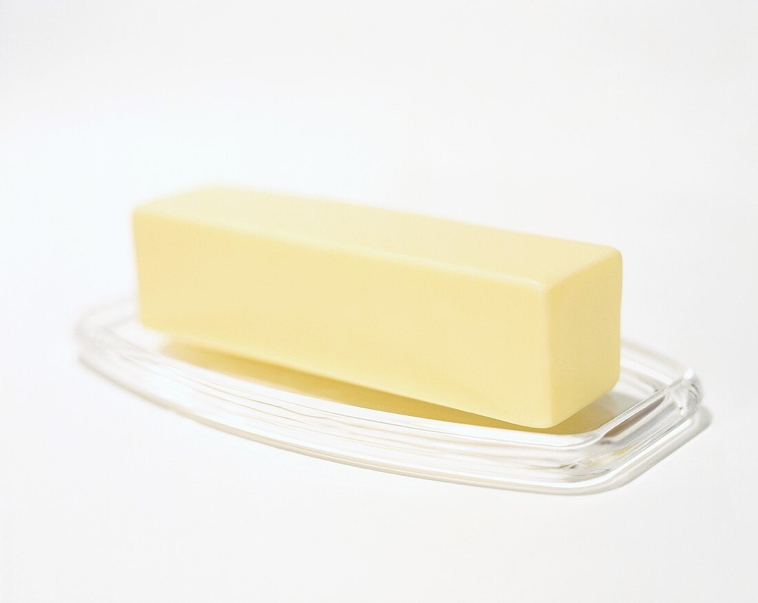 Stick of butter on glass dish