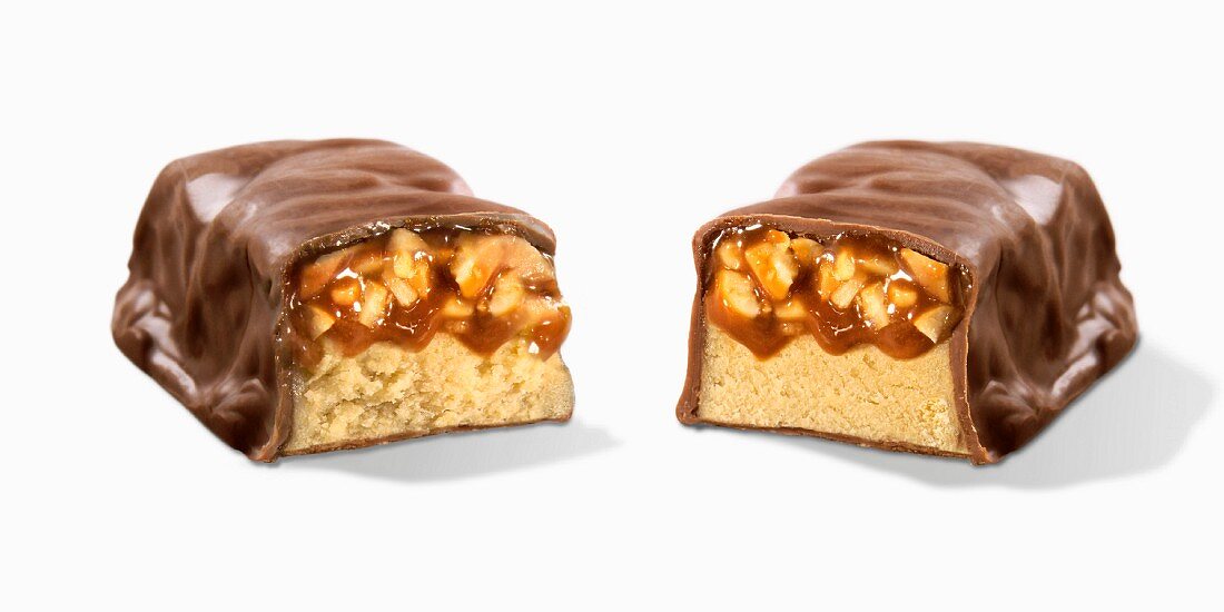A nut and caramel bar, cut in half