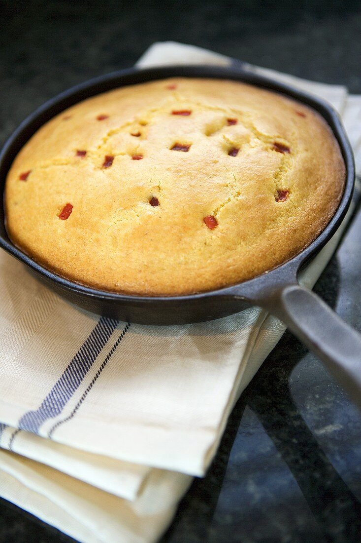 Cornbread with tomatoes in frying pan